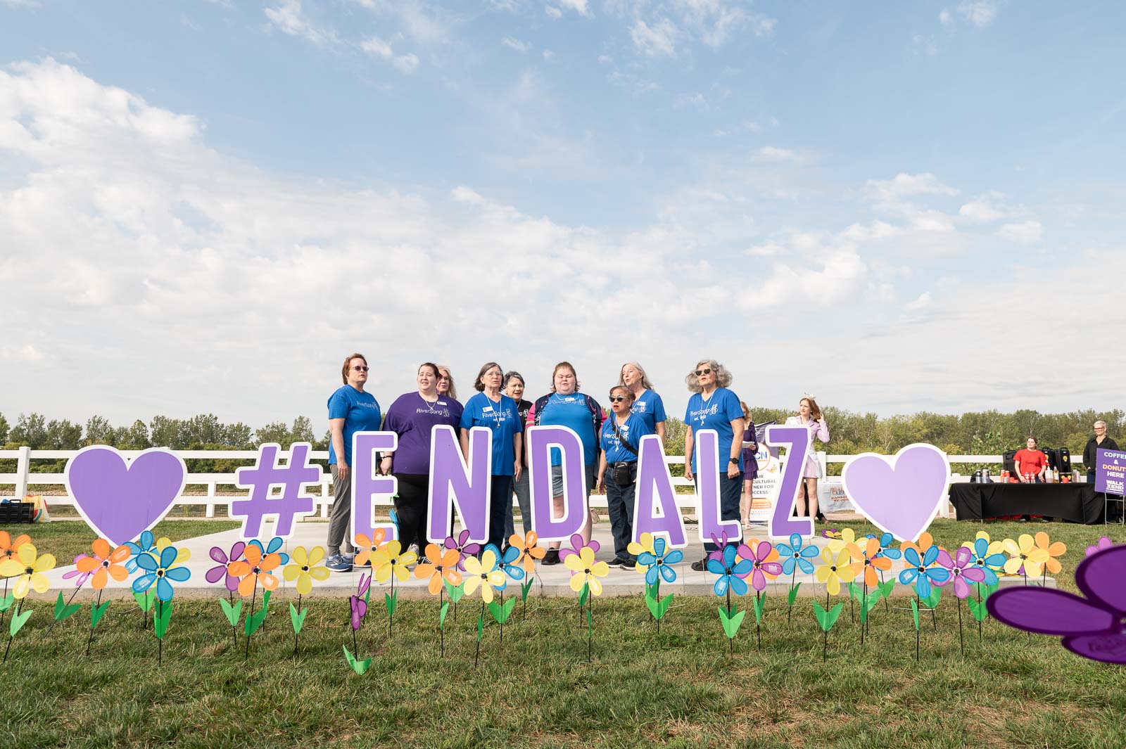 Participants standing behind large #ENDALZ sign with colorful flowers at the Walk to End Alzheimer’s in St. Joseph, Missouri.