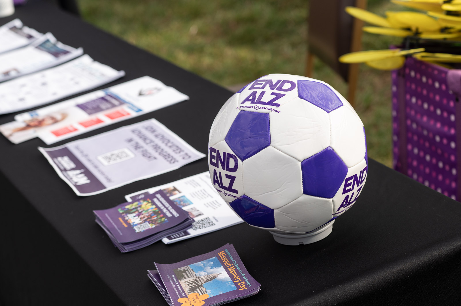 Purple and white soccer ball with END ALZ logo displayed on the information table during the Walk to End Alzheimer’s in St. Joseph, Missouri.