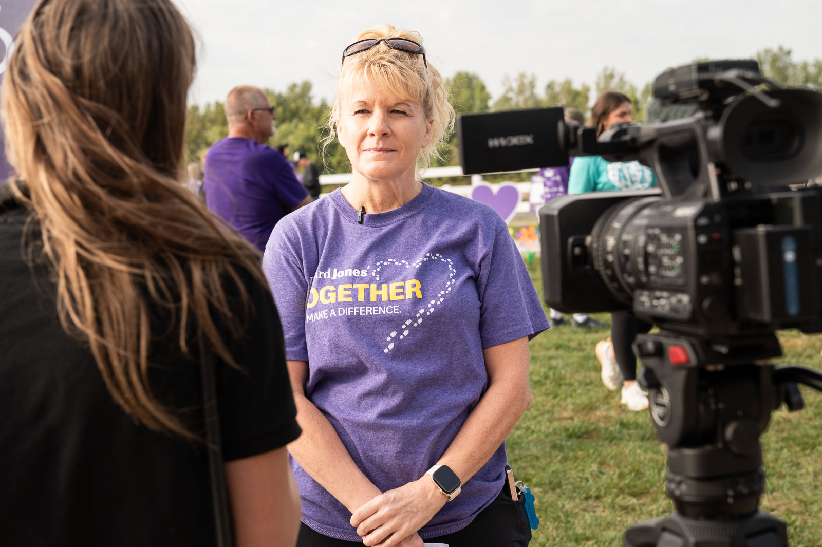 Volunteer in purple shirt being interviewed by local media during the Walk to End Alzheimer’s in St. Joseph, Missouri.